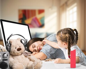 Mother working at home office with a cute small kid.