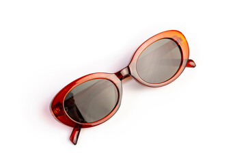 retro sunglasses an orange brown oval frame and dark lenses isolated on white background, front view, women's glasses