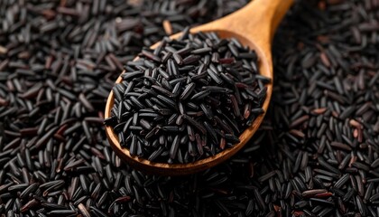 Close-up of dark rice in a wooden spoon