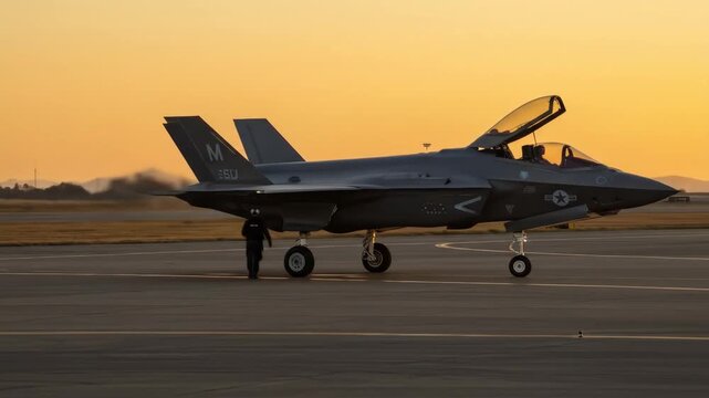 F-35 Lightning II Fighter Jet at Sunset - A Lockheed Martin F-35 Lightning II stealth fighter jet sits on a tarmac at sunset.