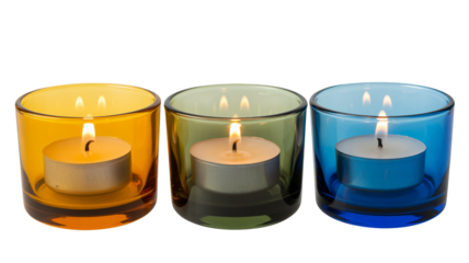 Vibrant candles burning brightly in colorful glass holders at night