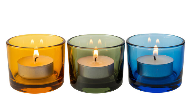 Vibrant candles burning brightly in colorful glass holders at night