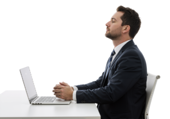 Young businessman practicing mindfulness meditation at his desk, taking a calming break from work for stress relief