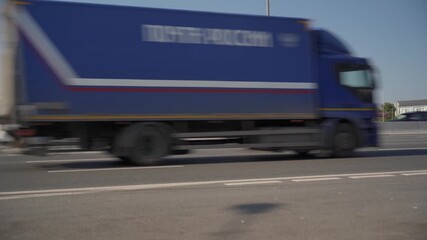 A busy highway with numerous cars and trucks passing by.