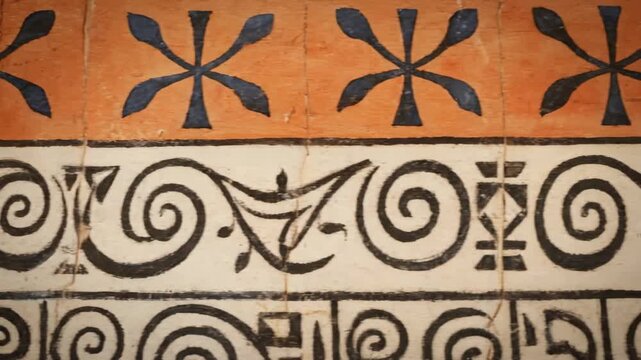 Ancient Mediterranean Swirl Pattern - Close-up shot of an ancient Mediterranean-inspired design featuring repeating swirls, floral motifs, and geometric patterns in black and orange on a white and