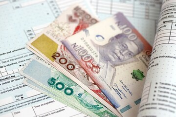 Nigerian naira money bills on tax form. Taxation and accounting concept
