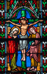 Stained glass (19th century) of Jesus Christ crucified on the cross represented with Marie and Saint John.