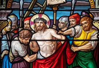 Obraz premium Stained glass (1914) of The Way of the Cross. Tenth station: Jesus is stripped of his clothes.