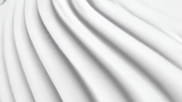 Abstract close-up view of smooth, flowing white fabric