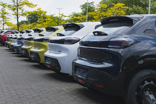 New Peugeot 208 cars parked outside a dealership building