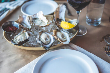 Oysters and Salmon on Trendy Ceramic Plate with Brown Paper Table Setting