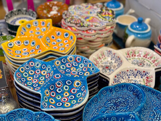 Colorful ceramic spoon rests and decorative bowls. Traditional hand-painted kitchenware, cultural artistry, and vibrant craftsmanship in everyday objects.