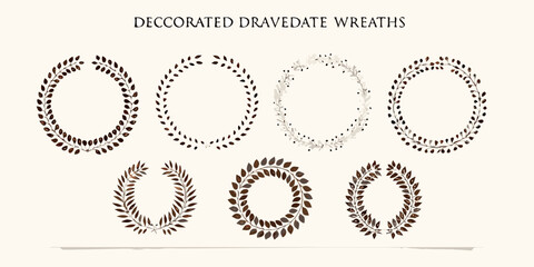 Collection of decorative wreaths with natural leaf and berry designs in earthy tones
