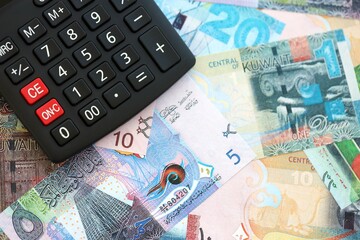 Kuwaiti dinar currency money bills and calculator. The concept of taxation and money count