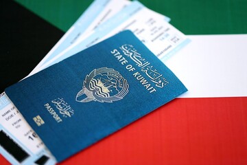 Kuwaiti passport and boarding pass tickets on flag. The concept of travel and vacation