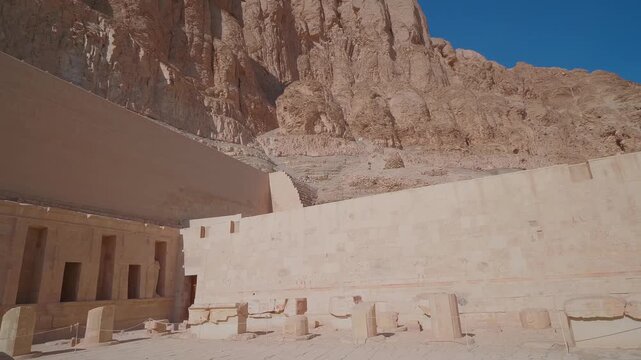 Footage showcasing the majestic Mortuary Temple of Hatshepsut, a stunning example of ancient Egyptian architecture carved into the cliffs of Deir el Bahari on the West Bank of the Nile in Luxor, Egypt