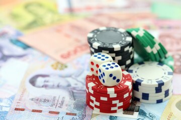 Thai baht currency money bills and casino chips with dice. The concept of gambling and casino