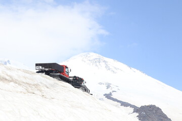 Snowcats Against The Backdrop Mount