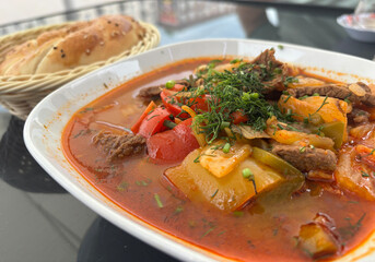 Chorba lamb soup, shurpa in Arabic restaurant. Kazakh meal with meat, spices and vegetables