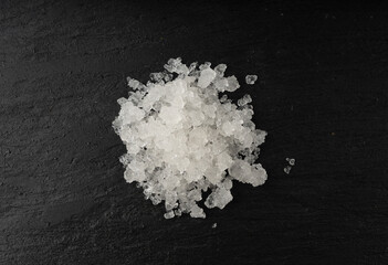 Obraz na płótnie Canvas Dead sea salt pile, white crystals for body spa, sodium chloride similar to crushed ice, spa scrub