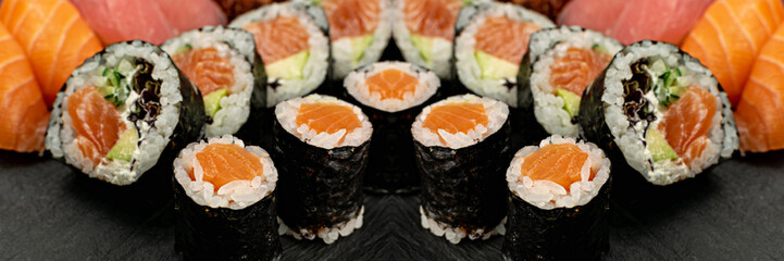 Set of Various Japanese Sushi Food on Dark Sate Plate Closeup. Nigiri and Nori Maki Sushi Rolls