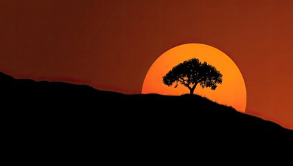 Silhouette of a lone tree atop a hill at sunset.  A large, orange sun rises above a dark silhouette of a hill