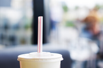 Refreshing Beverage with Straw in a Modern Setting