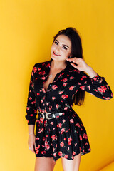 Portrait of a beautiful woman in a black flower dress with a smile