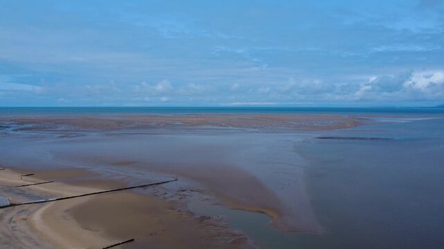 aerial view of the beach and sea in Fleetwood Lancashire at low tide with the large expanse of sand looking across Morecambe Bay to the village of Heysham and the Nuclear power station in the distance