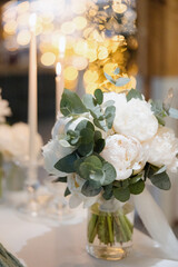 Elegant floral arrangement captures the essence of a romantic evening celebration with soft lighting