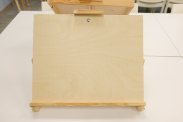 Crafting a blank canvas on a wooden easel in a cozy creative workshop