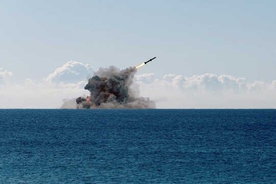 Rocket launch from the sea with clouds of smoke and fire, military exercises and weapons tests.