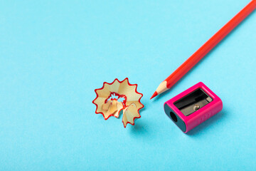 Pencil sharpener on bright colored background. Pencil and pencil shavings. Stationery. School...