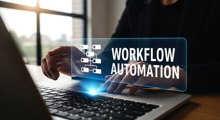 Person using laptop with workflow automation graphic overlaying the screen in a bright office space