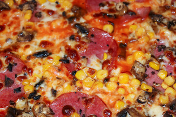 Delicious pizza topped with pepperoni, corn, mushrooms, and melting cheese, creating a mouthwatering feast ideal for gatherings, parties, or casual dining.