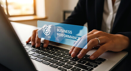 Person typing on a laptop with a business performance kpi graphic overlayed on the screen view