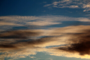 Striking clouds painted with the warm hues of sunset