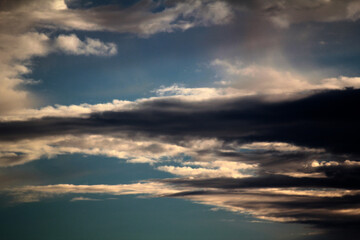 Striking clouds painted with the warm hues of sunset