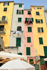 Colorful facades of narrow tower-houses from the Genoese era on Via Calata Doria Street facing the inner basin of the port. Porto Venere-Liguria-274