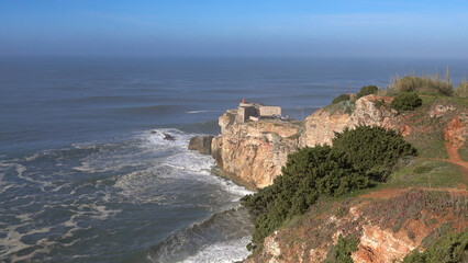 Lighthouse on coast of Atlantic ocean in Nazare