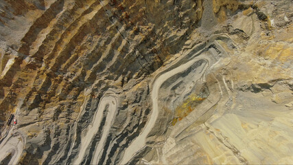 Aerial of open mine and heavy mining equipment