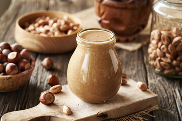 Homemade hazelnut butter in a glass jar on a table