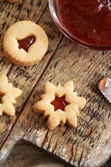 Traditonal Linzer Christmas cookies filled with strawberry marmalade on a table