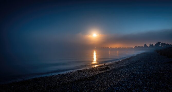Misty sunrise over a tranquil beach