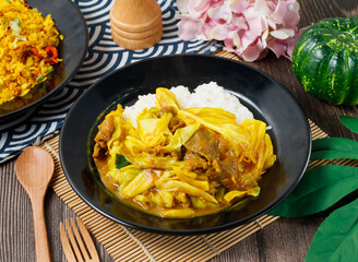 Curry with beef and cabbage served over fluffy white rice in bowl side view of hong kong food
