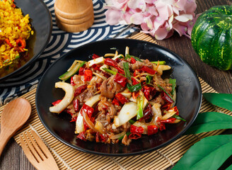 Dry Pot Beef, a spicy stir fry with dried chilies and onions in bowl side view of hong kong food