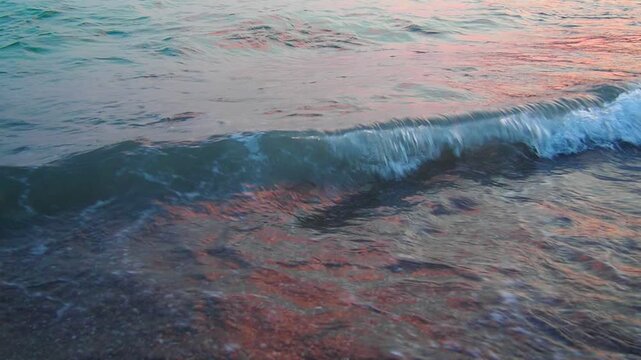 Morning sunlight reflects off the gentle waves lapping the sandy shore at Canj, Montenegro. The tranquil atmosphere and calm waters create a perfect beach scene along the Mediterranean coast