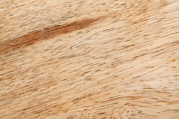 Mango wood texture top view. Kitchen wooden tray background, organic Mangifera indica veneer