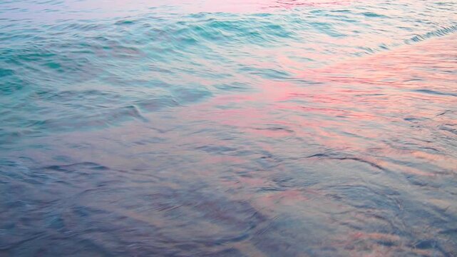 Waves softly lap at the sandy beach of Canj in Bar, Montenegro as the sun rises over the Mediterranean. The tranquil morning atmosphere invites relaxation and reflection