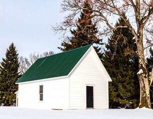 White cabin with green roof in snowy landscape